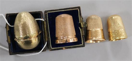 Three 9ct gold thimbles including Charles Horner, Chester, 1922 and one in egg shaped case and one other yellow metal thimble.